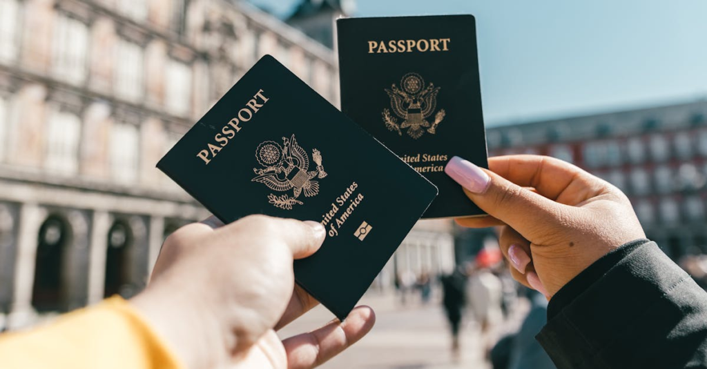 Travelers holding US passports at Plaza Mayor, Madrid, highlighting tourism and exploration.