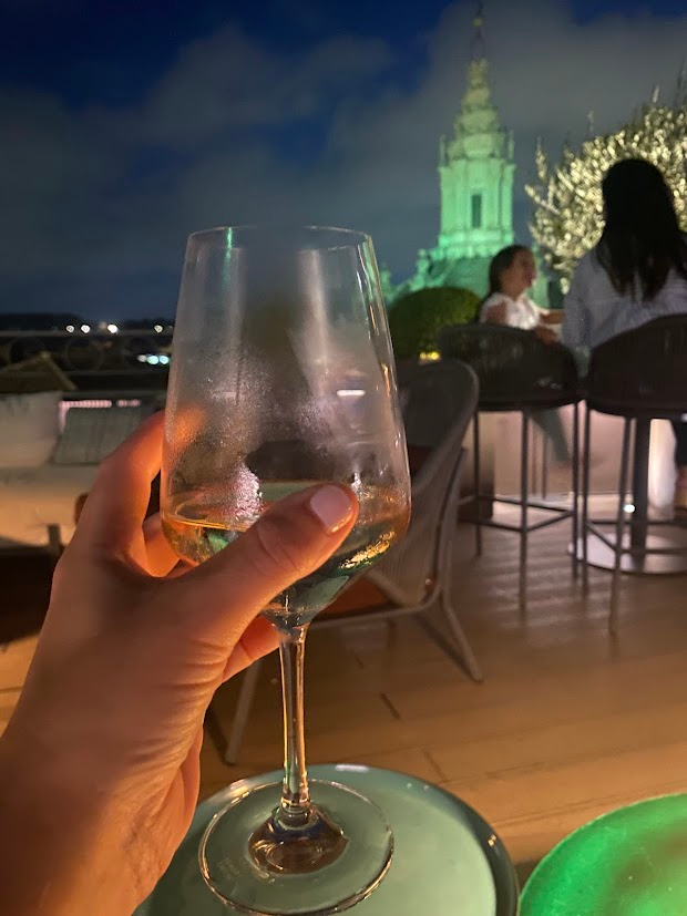 glass of white wine on rooftop bar at night